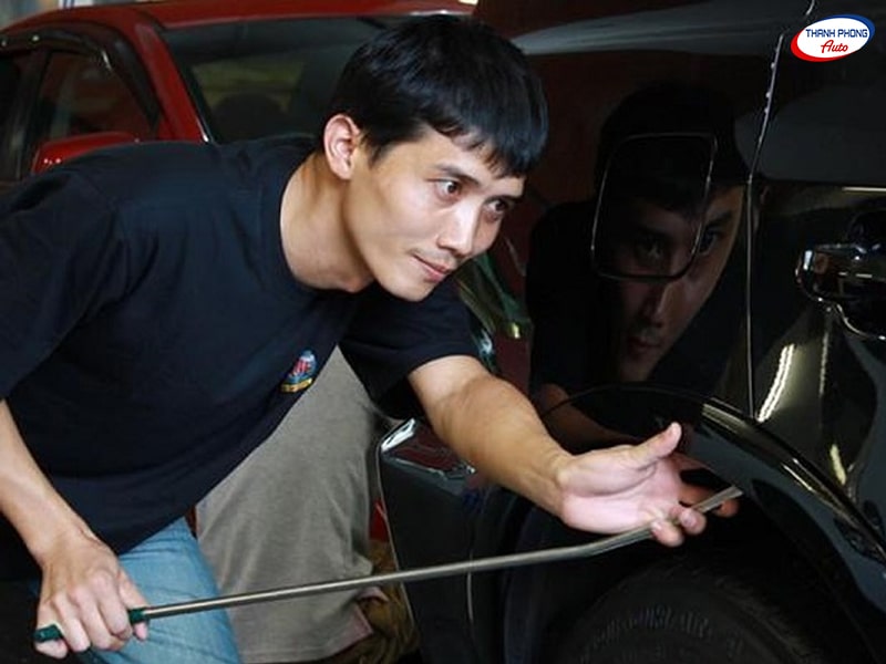 Xử lý vết móp ô tô bằng thanh kim loại cứng có đầu cong - 8 Cách Tự Sửa Vết Lõm, Móp Trên Ô Tô Tại Nhà Hiệu Quả Xử lý vết móp ô tô bằng thanh kim loại cứng có đầu cong